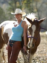 USA, Colorado, Cowgirl with horse on ranch. Photo : John Kelly
