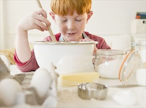 Portrait of boy (8-9) preparing cake. Photo : Jamie Grill Photography