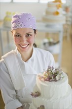 Portrait of young woman with wedding cake.