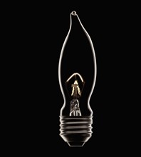 Energy saving bulb on black background, studio shot. Photo : Mike Kemp