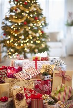 Colorful gifts and christmas tree in the background.