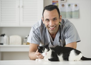 Vet stroking cat in pet clinic.