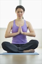 Young woman meditation in lotus position.