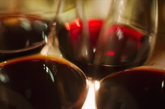 Close-up view of red wine glasses.