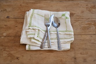 Close up of silverware on dish towel.