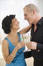 Happy mature couple with flutes.