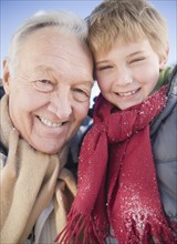Portrait of grandfather with grandson (8-9) in winter. Photo : Jamie Grill Photography