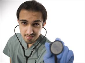 Young surgeon holding stethoscope. Photo : Dan Bannister