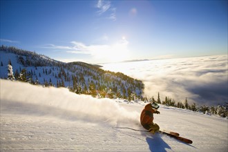 USA, Montana, Whitefish, Male skier on mountain slope at sunrise. Photo : Noah Clayton