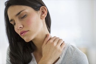 Woman suffering from neck pain.