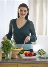 Young attractive woman preparing food.