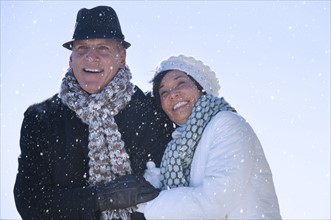 Happy mature couple in winter scenery.