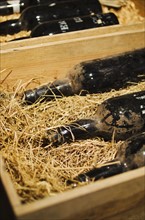 Old wine bottles in wooden box.