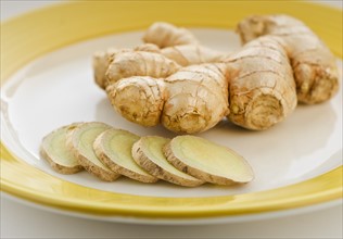 Close up of ginger root and slices.