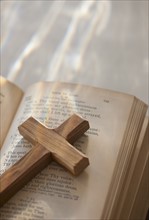 Studio shot of wooden cross and bible.