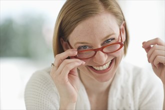 Portrait of woman wearing glasses and smiling.