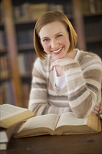 Portrait of woman in library.