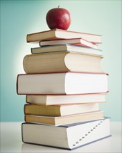 Apple on stack of books. Photo: Jamie Grill Photography