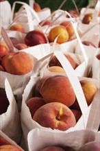 Bags with peaches. Photo: Tetra Images