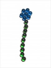 Flower arranged of blue and glass balls. Photo: David Arky