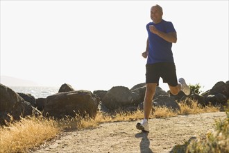 USA, California, Berkeley, Senior man jogging. Photo: Noah Clayton
