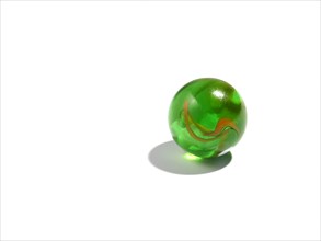 Studio shot of small green glass ball. Photo : David Arky
