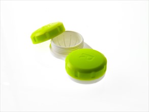 Green contact lens cases on white background. Photo: David Arky