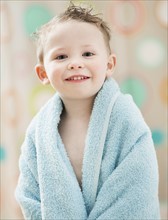 Portrait of boy (2-3) wrapped in towel. Photo: Mike Kemp