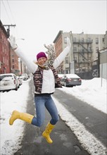 USA, New Jersey, Jersey City, woman jumping on street. Photo : Jamie Grill Photography