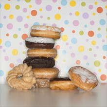 Heap of doughnuts with spotted background.