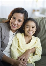 Portrait of smiling mother embracing daughter (6-7).