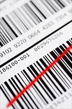 Close up of barcode with red line.