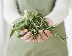 Woman holding herbs.