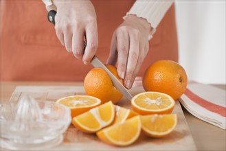 Woman cutting oranges.