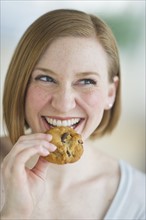 Woman eating cookies.