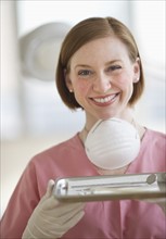 Dental assistant holding tray.