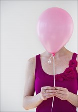 Woman holding balloon.