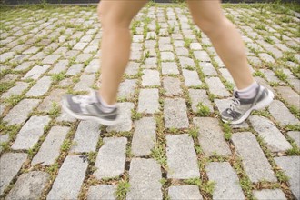 Blurred legs of woman jogging. Photo : Kristin Lee