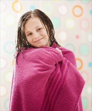 Portrait of girl (10-11) wrapped in towel. Photo : Mike Kemp