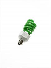 Green energy efficient lightbulb on white background. Photo : David Arky
