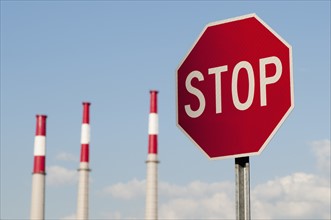 Stop sign with factory chimneys in background. Photo: Antonio M. Rosario