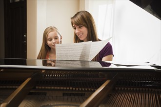 Girl (8-9) assisting mother with music score. Photo: Mike Kemp