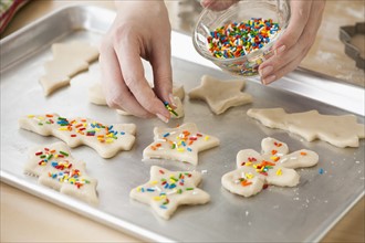Woman preparing biscuits with pastry cutter.