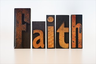 Letterpress showing word "faith".