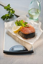 Slice of salmon on weight scale.