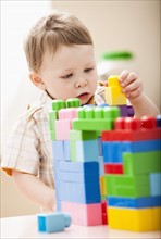 Boy (2-3) playing with colorful blocks. Photo : Mike Kemp