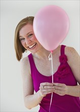 Woman holding balloon.