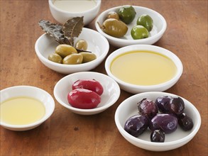 Close up of bowls with olives and sauces.
