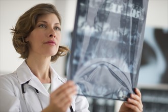 Portrait of doctor holding x-ray image.