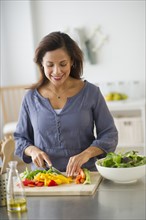 Woman preparing food in kitchen.